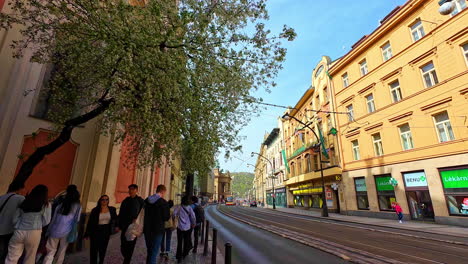 People-walking-on-Narodni-Trida-avenue-in-city-center-on-sunny-morning