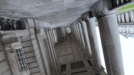 Observing-the-inverted-perspective-of-the-colonnade-at-London's-Greenwich---Old-Naval-College,-fostering-a-sense-of-travel-and-appreciation-for-architectural-beauty