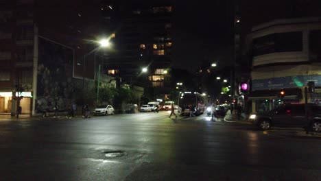 Vibrant-cityscape-of-buenos-aires-city-traffic-under-rainy-weather-road-intersection-cars-driving-by-dusk-south-american-dusky-downtown