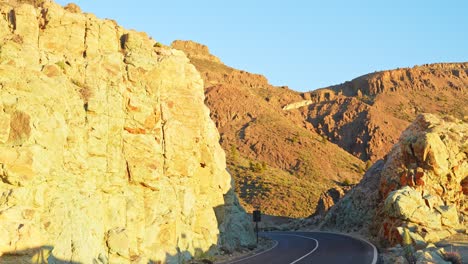 Yellow-color-cliff-and-mountain-road-in-Tenerife,-golden-hour-shot
