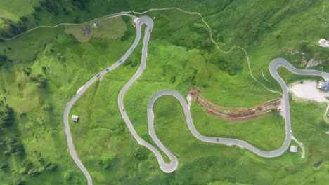 Aerial-view-of-vehicles-driving-on-the-winding-roads-of-Passo-Gardena-in-the-Dolomites-Mountains,-Trentino,-South-Tyrol,-Italy