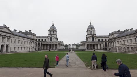 Explorers-at-the-forefront-of-London,-Greenwich---Old-Naval-College,-an-architectural-marvel,-embodying-the-spirit-of-travel-and-discovery