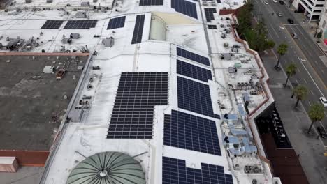 Solar-panels-on-the-roof-of-a-shopping-mall---aerial-flyover-inspection