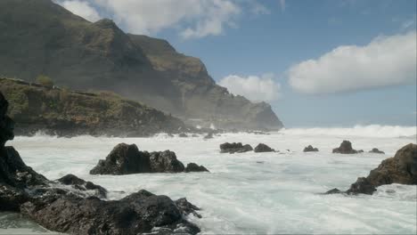 Dangerous-slowmotion-ocean-waves-crushing-on-sharp-volcanic-rocks-near-Punta-Negra,-Buenavista-del-Norte,-Tenerife,-Canary-Islands-in-spring