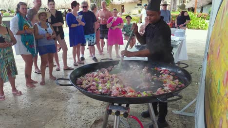 Chef-runs-cooking-class-in-front-of-resort-guests-at-Impressive-Resorts-and-Spa-at,-Punta-Cana,-Dominican-Republic