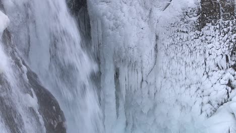 Ice-covered-rocks-and-waterfall,-Helgufoss,-Iceland.-2024