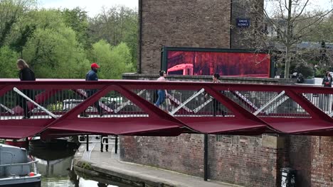 Crossing-the-bridge-above-Regents-Canal,-London,-United-Kingdom