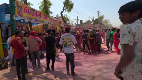 pov-shot-Many-people-are-walking-on-the-road-and-there-are-many-stalls-of-many-different-things-like-gulal