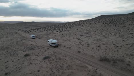 Camper-Vans-Driving-In-The-Desert-Near-Salt-Lake-City,-Utah,-USA---Aerial-Drone-Shot