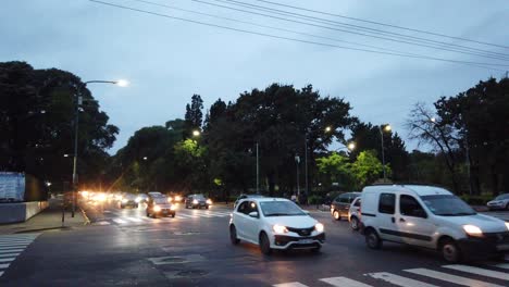 Cars-driving-at-gaona-avenue-fast-lane-night-sunset-at-buenos-aires-irlanda-urban-park-greenery-of-buenos-aires-city-argentina-dusk-skyline