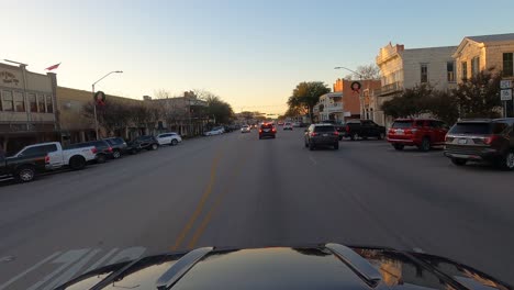 Car-driving-at-sunset-during-Christmas-and-COVID-19-lockdown,-Fredericksburg,-Texas,-USA,-POV-wide-shot