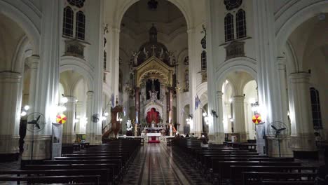 Inside-Basilica-our-lady-of-Buenos-Aires-caballito-architecture-religious-white-house-catholic-believes,-building-at-night-people-praying-service,-argentina-south-american-religion