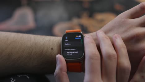 Close-up-using-smartwatch-on-wrist,-scrolling-menu-options-and-tapping-screen