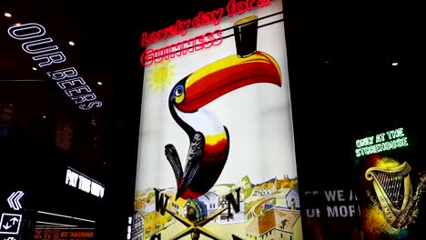 Panning-shot-of-Guinness-Storehouse-toucan-publicity-in-Dublin,-Ireland