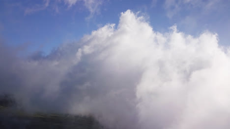 Drone-view-of-high-white-clouds-moving-over-the-Haleakala-volcano-on-Maui,-Hawaii-at-daylight