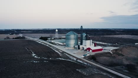 drone-shot-pulling-away-from-a-grain-solo-on-an-isolated-rural-farm