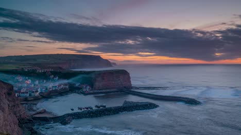 Sunset-over-the-North-Yorkshire-fishing-village-of-Staithes-with-the-harbour-nestled-within-the-cliffs