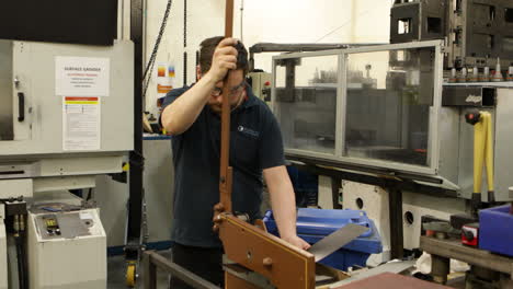 Worker-Cutting-Sheet-Metal-On-A-Guillotine-Sheer