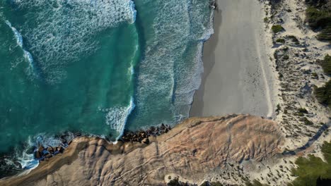 Antena-Arriba-Hacia-Abajo-De-La-Playa-De-Salmón-Con-Agua-Arenosa-Y-Clara-Del-Océano-Al-Atardecer