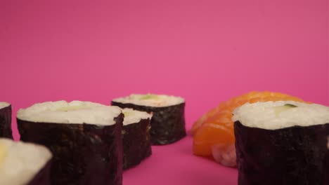 Studio-shot-of-sushi-rolls-on-pink-background