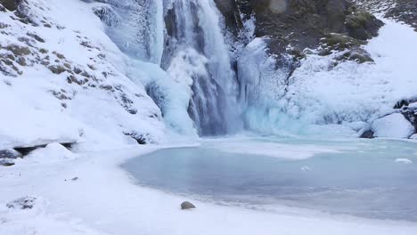 Helgufoss-waterfall-covered-in-ice.-Early-Spring.-Iceland