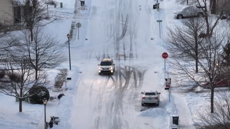 Toyota-RAV4-driving-on-snow-and-ice-covered-roads-in-suburban-American-neighborhood-during-winter