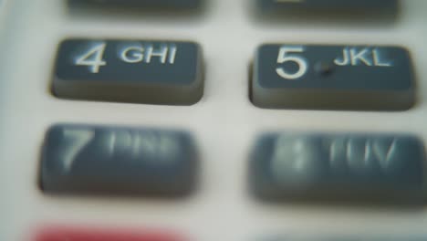 A-macro-close-up-shot-of-a-pin-pad-numbers-and-letters-on-colorful-buttons,-smooth-zoom-in-movement,-Full-HD-video,-super-slow-motion,-blurry-depth-of-field