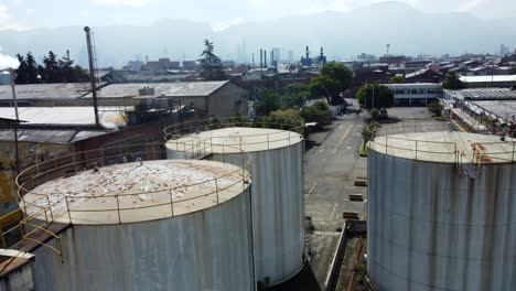 Among-the-relics-of-industry,-four-enormous-rusty-water-tanks-stand-as-imposing-monuments-to-the-factory's-former-operations