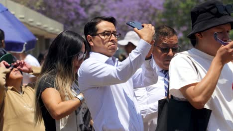 Latin-clerk-man-taking-a-photo-of-the-solar-eclipse-from-his-smartphone,-Mexico-April-8,-2024