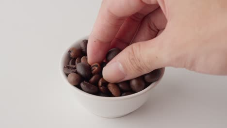 Geröstete-Kaffeebohnen-Werden-Mit-Der-Hand-Berührt,-Um-Ihre-Textur-Zu-Testen