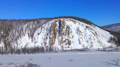 drone-flyover-near-a-beautiful-mountain-in-winter-4k
