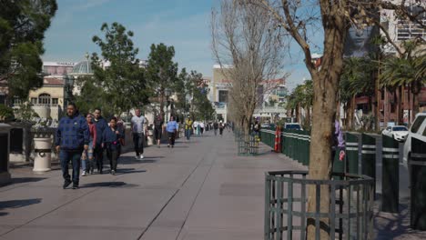 People-Walking-On-The-Sidewalk-Along-The-Las-Vegas-Boulevard-In-Nevada,-USA