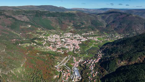 High-angle-drone-view-of-Manteigas-village-in-valley,-Serra-da-Estrela,-Portugal