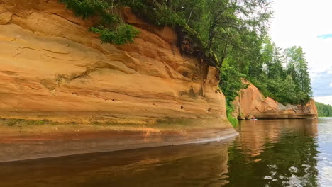 Erglu-sandstone-cliffs-alone-the-Gauja-River-as-seen-from-a-boat-or-canoe