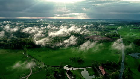 Drone-shot-over-Latvia's-rural-farmland-on-a-sunny-day
