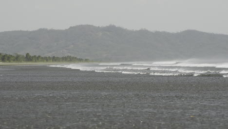 Low-angle-shot-of-waves-crashing-on-the-shore-of-Canas-Island-at-low-tide
