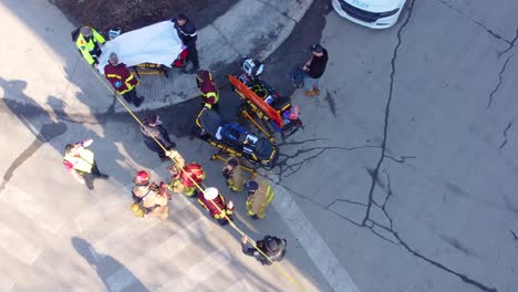 An-emergency-response-team-at-a-fatal-shooting-crime-scene,-sunny-day-in-montréal,-aerial-view