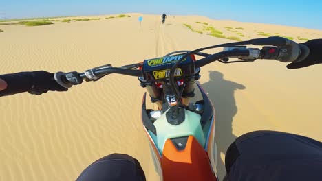 Riders-racing-at-speed-across-sandy-terrain