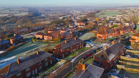 Drone's-eye-winter-view-captures-Dewsbury-Moore-Council-estate's-typical-UK-urban-council-owned-housing-development-with-red-brick-terraced-homes-and-the-industrial-Yorkshire