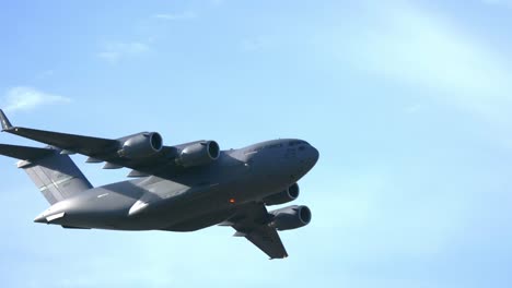 Military-Transport-C-17-Heavy-Cargo-Plane-Overflying---Low-Angle-Track