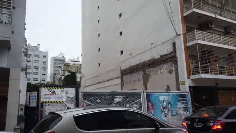 Demolished-space-area-between-buildings-at-bustling-latin-city-overdevelopment-urban-area-of-buenos-aires-town-argentina,-car-traffic-bustling