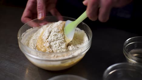 Cook-prepares-pudding-by-mixing-ingredients-in-a-glass-bowl