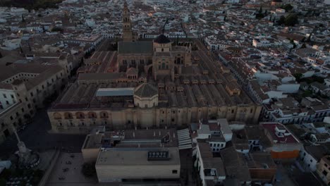 circling-aerial-view-of-mosque-cathedral-in-Cordoba,-Spain-during-blue-hour