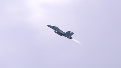 F18-Fighter-Jet-Pulls-Up-to-Steep-Climb-with-Afterburner-TRACK