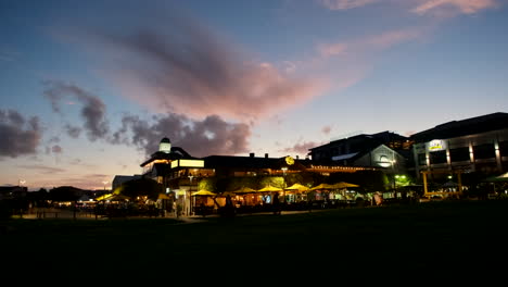 Hermanus-waterfront-restaurants-illuminated-at-twilight-with-vivid-sky