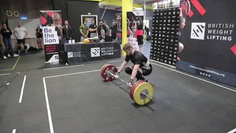 Male-athlete-failing-a-clean-and-jerk-wearing-a-black-singlet