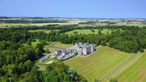 Aerial-View-of-Famous-Scottish-Castle-and-Garden-in-Scottish-Borders,-Famous-Landmark-in-Kelso,-Scotland,-United-Kingdom