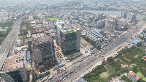 Aerial-Drone-shot-of-Vehicles-passing-through-the-city-near-Shell-building