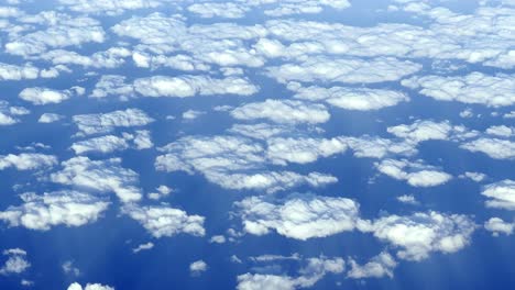 Flying-Above-Beautiful-Clouds,-View-From-The-Window-Of-An-Airplane---POV