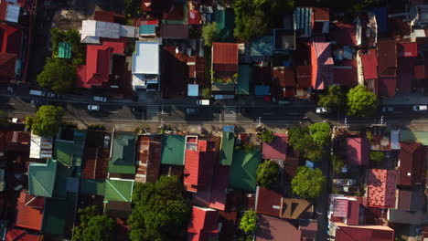 Top-down-drone-shot-above-traffic-on-the-streets-of-sunny-San-Pablo,-Laguna,-Philippines